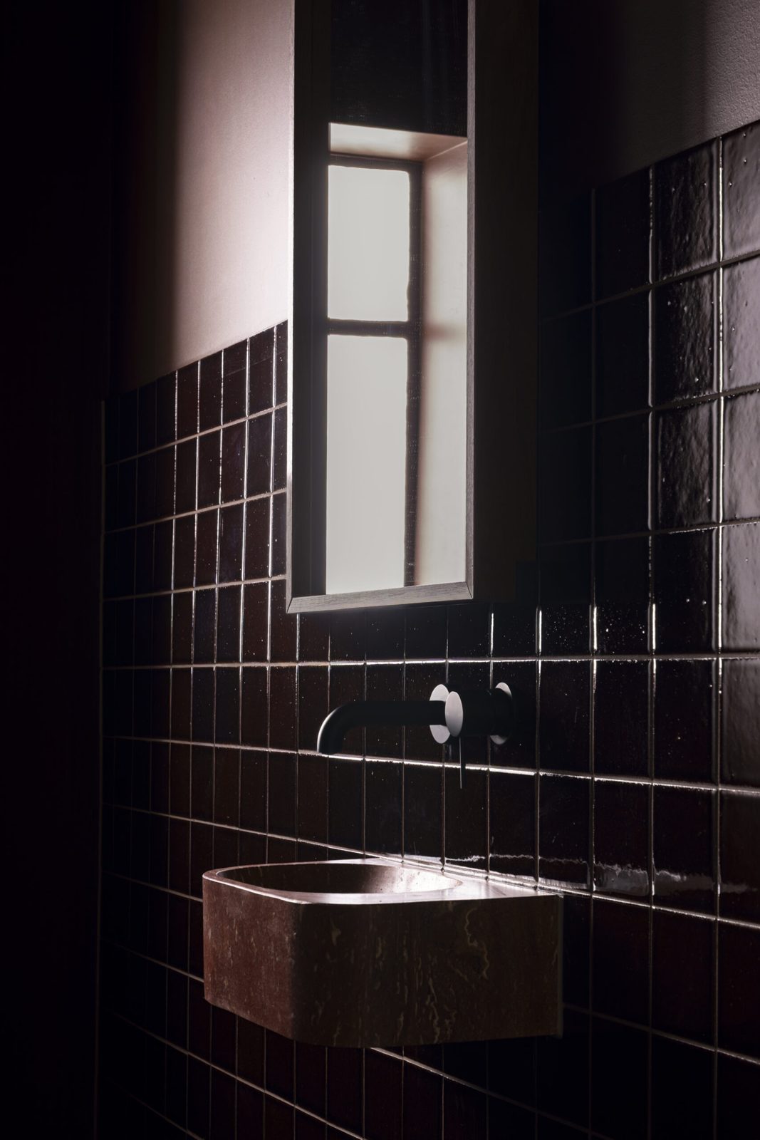 Espresso square-tiled treatment room softened by window light